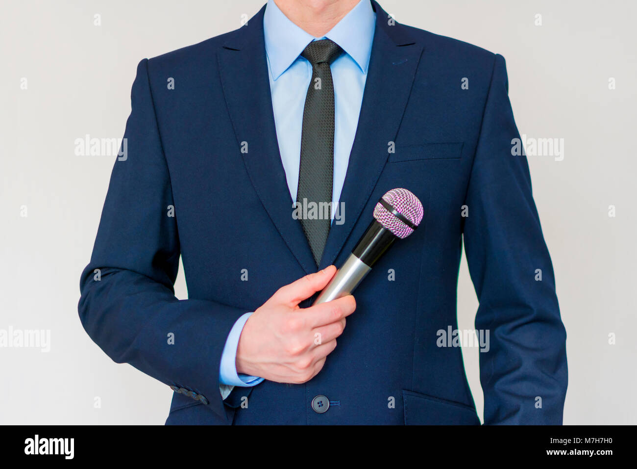 Man in suit holding a microphone hi-res stock photography and images ...