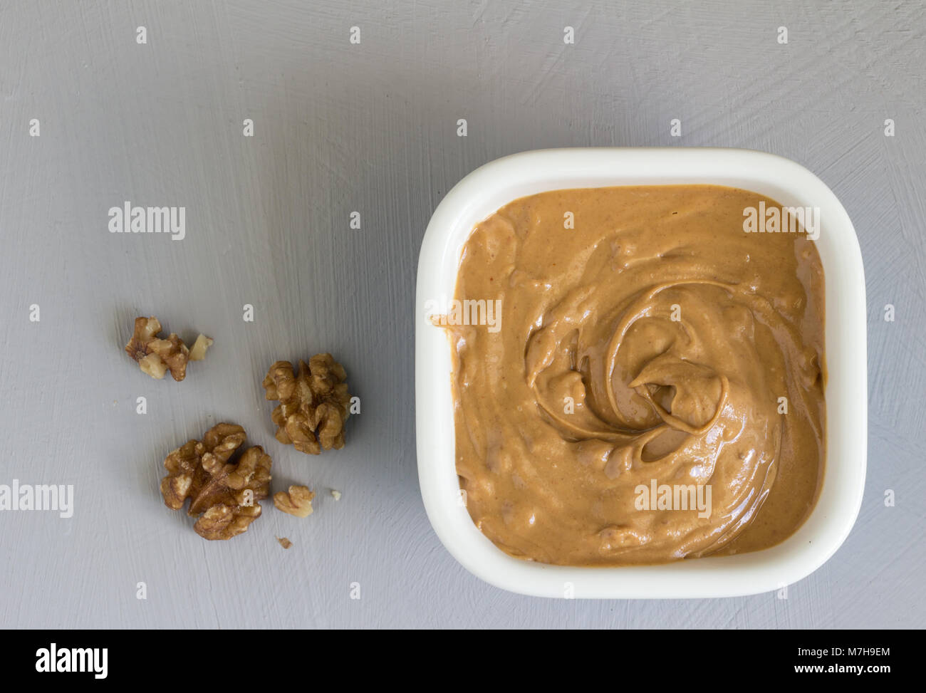 Walnut butter with walnuts close up top view Stock Photo