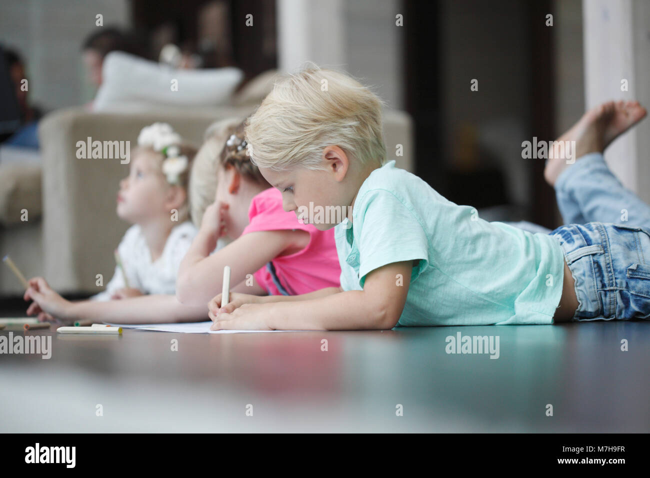 Group of cute children drawing with colorful pencils on floor Stock ...