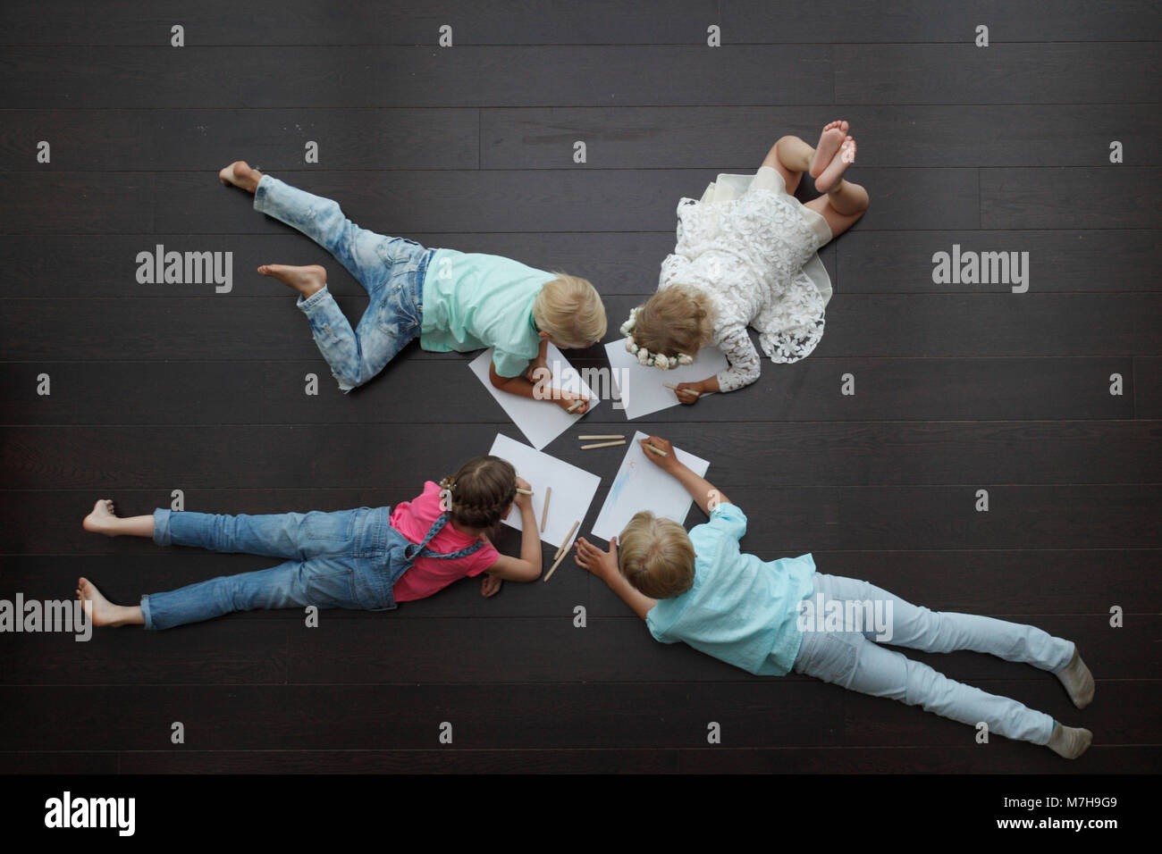 Group of cute children drawing with colorful pencils on floor Stock ...