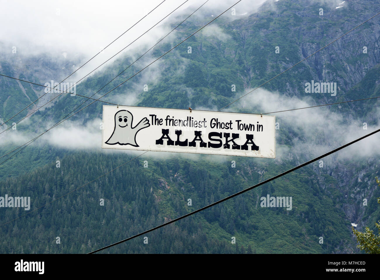 A welcome sign hangs above the road entrance to the old mining town of Hyder, Alaska, USA, across the border with Stewart, British Columbia, Canada. Stock Photo
