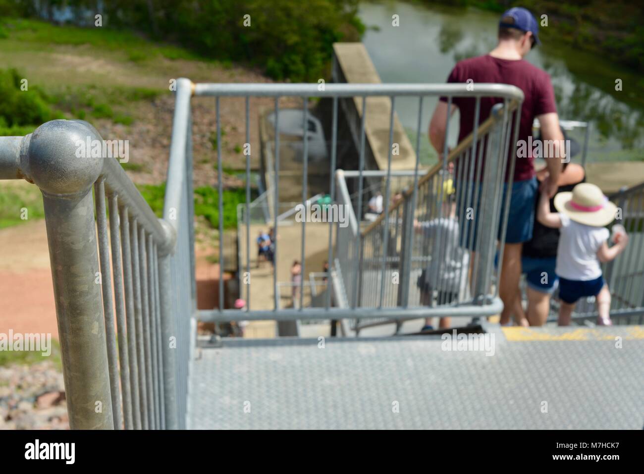 Father and son walking down galvanised steel stairs, Ross River Dam, Ross Dam Access, Kelso QLD, Australia Stock Photo