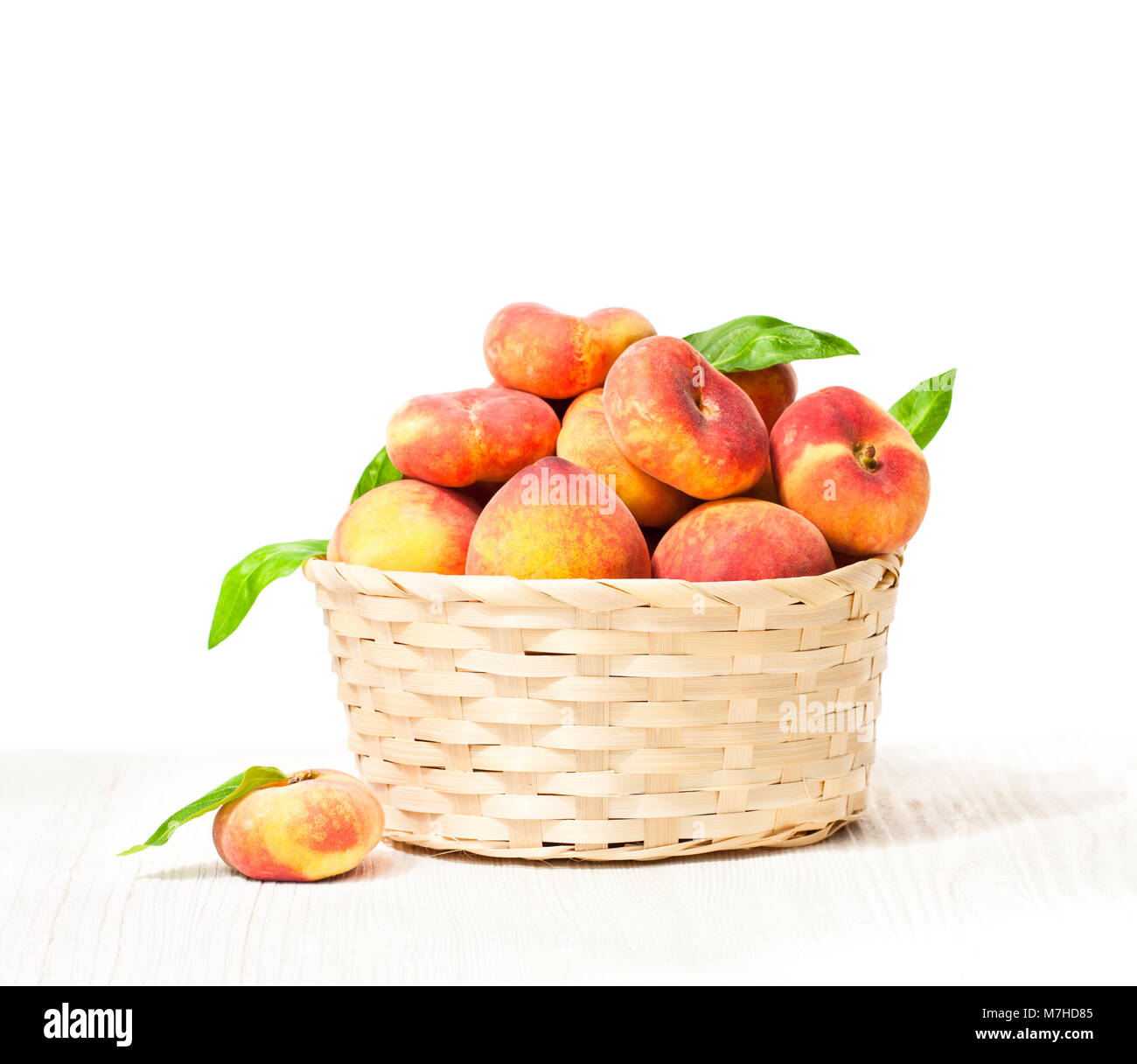 peaches in basket isolated Stock Photo Alamy
