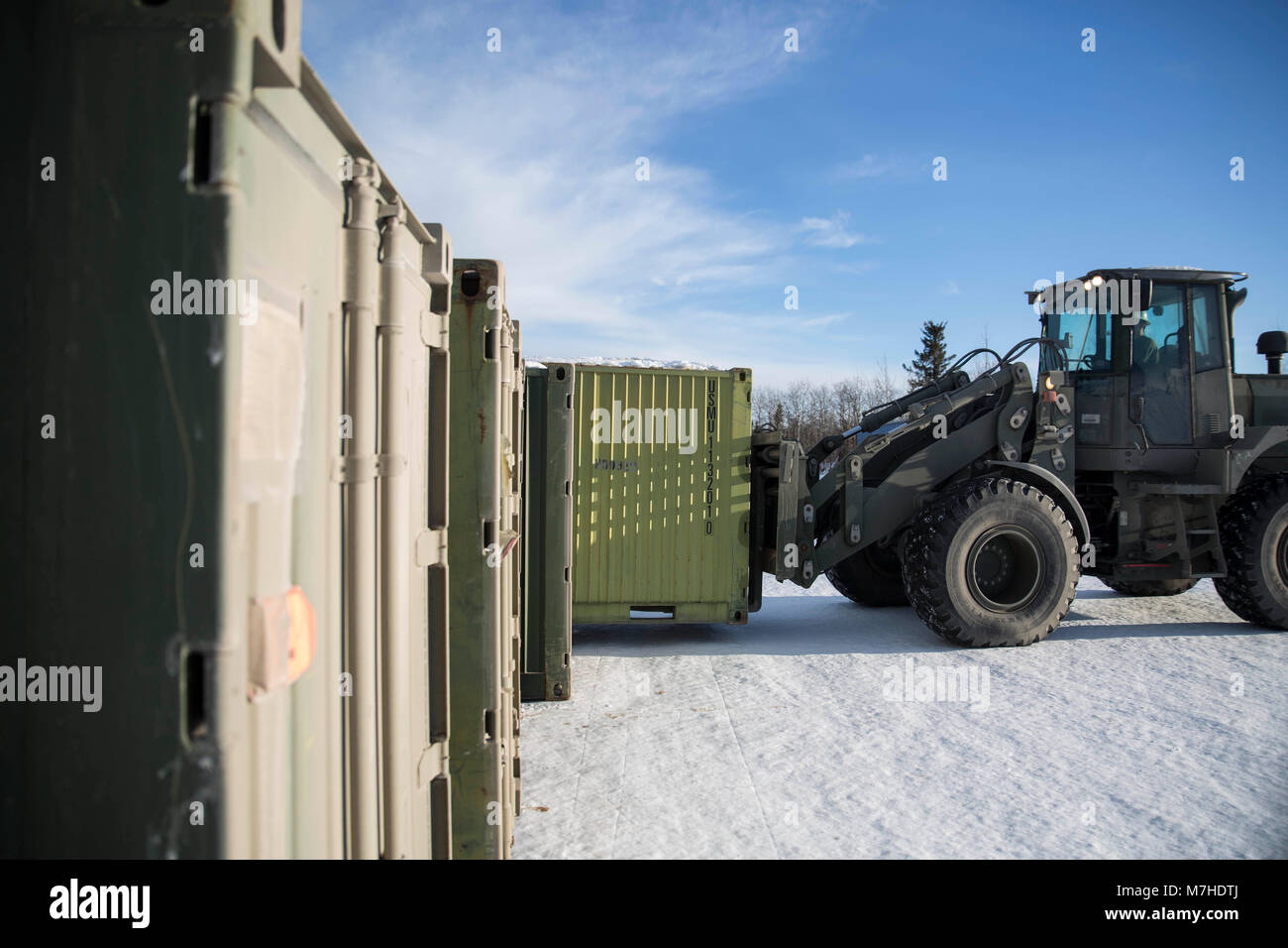 A Marine with Combat Logistics Regiment 25 moves a quadcon full of gear at Fort Greely, Alaska in preparation for Exercise Arctic Edge 18, March 10, 2018. Arctic Edge 18 is a biennial, large-scale, joint-training exercise that prepares and tests the U.S. military’s ability to operate tactically in the extreme cold-weather conditions found in Arctic environments with more than 1500 participants from the Air Force, Army, Coast Guard, Marine Corps, and Navy utilizing the unique and expansive air and ground training areas in Alaska. (U.S Marine Corps photo by Sgt. Brianna Gaudi) Stock Photo