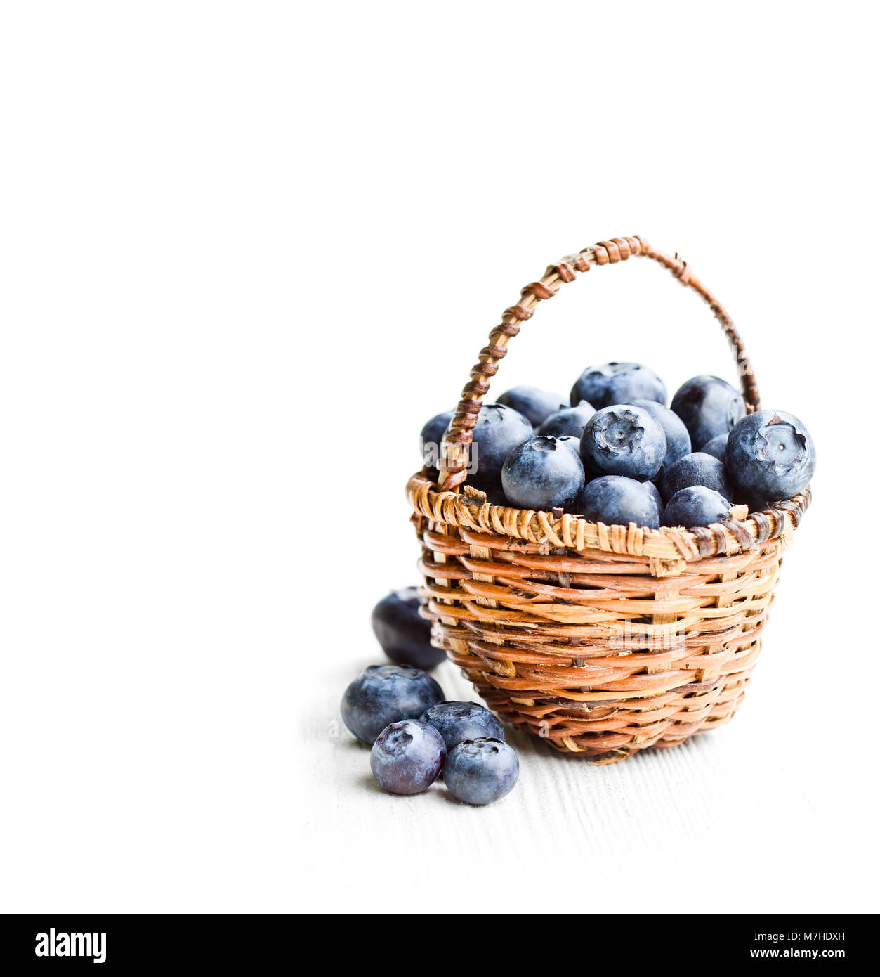 blueberries in wicker basket isolated on white background Stock Photo