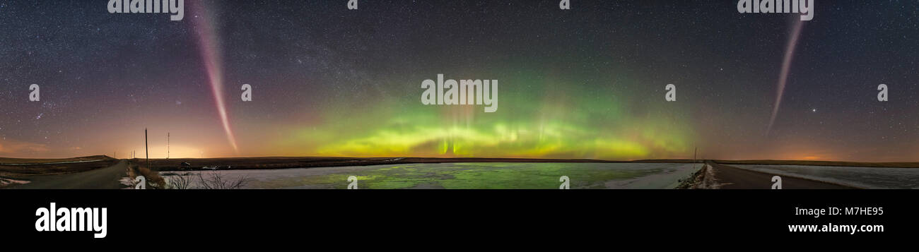 An aurora display glowing pink in color with green fringe, Alberta, Canada Stock Photo