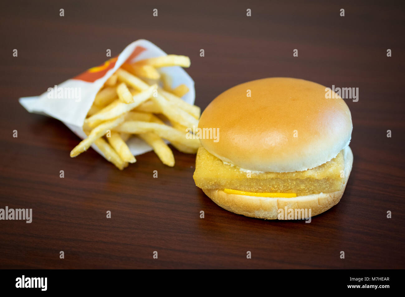 A McDonald's Filet-O-Fish, a fish sandwich, and a small french fries. Stock Photo