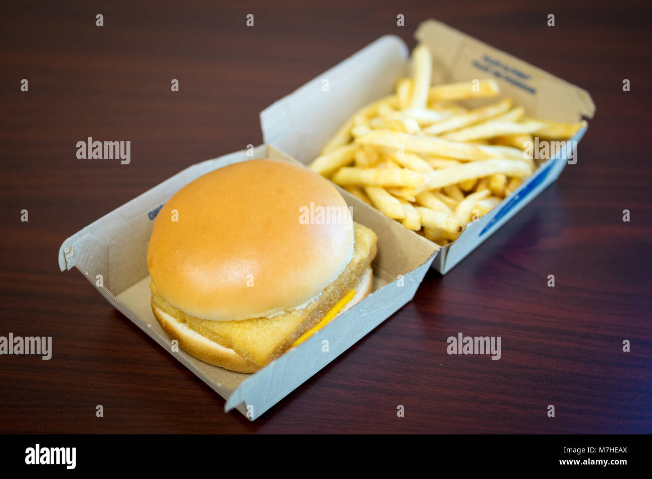 A McDonald's Filet-O-Fish, a fish sandwich, and a small french fries. Stock Photo