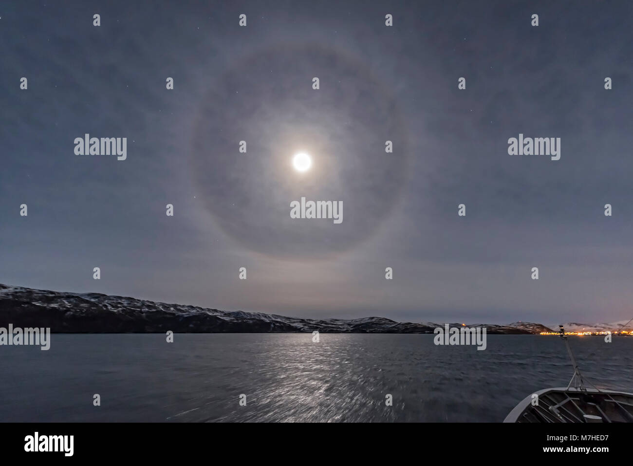 A halo around the nearly full moon over the Barents Sea in northern Norway. Stock Photo