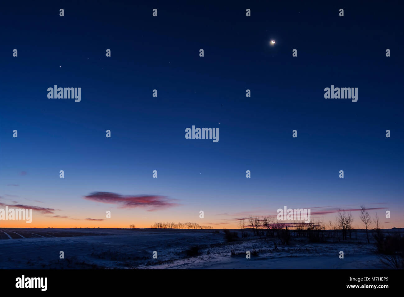 Venus and Jupiter in close conjunction very low in the southeast sky, Alberta, Canada. Stock Photo