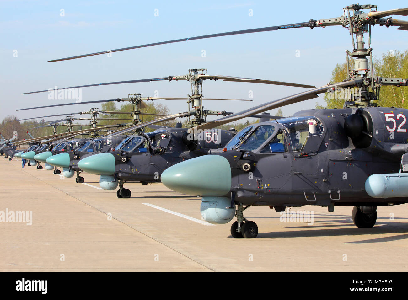 Row of Ka-52 Alligator attack helicopters of the Russian Air Force. Stock Photo