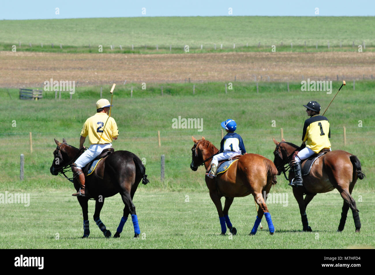 A junior polo player with his parents at the annual cowboys versus polo players friendly polo match at the historic Bar U Ranch in Longview, Alberta,  Stock Photo