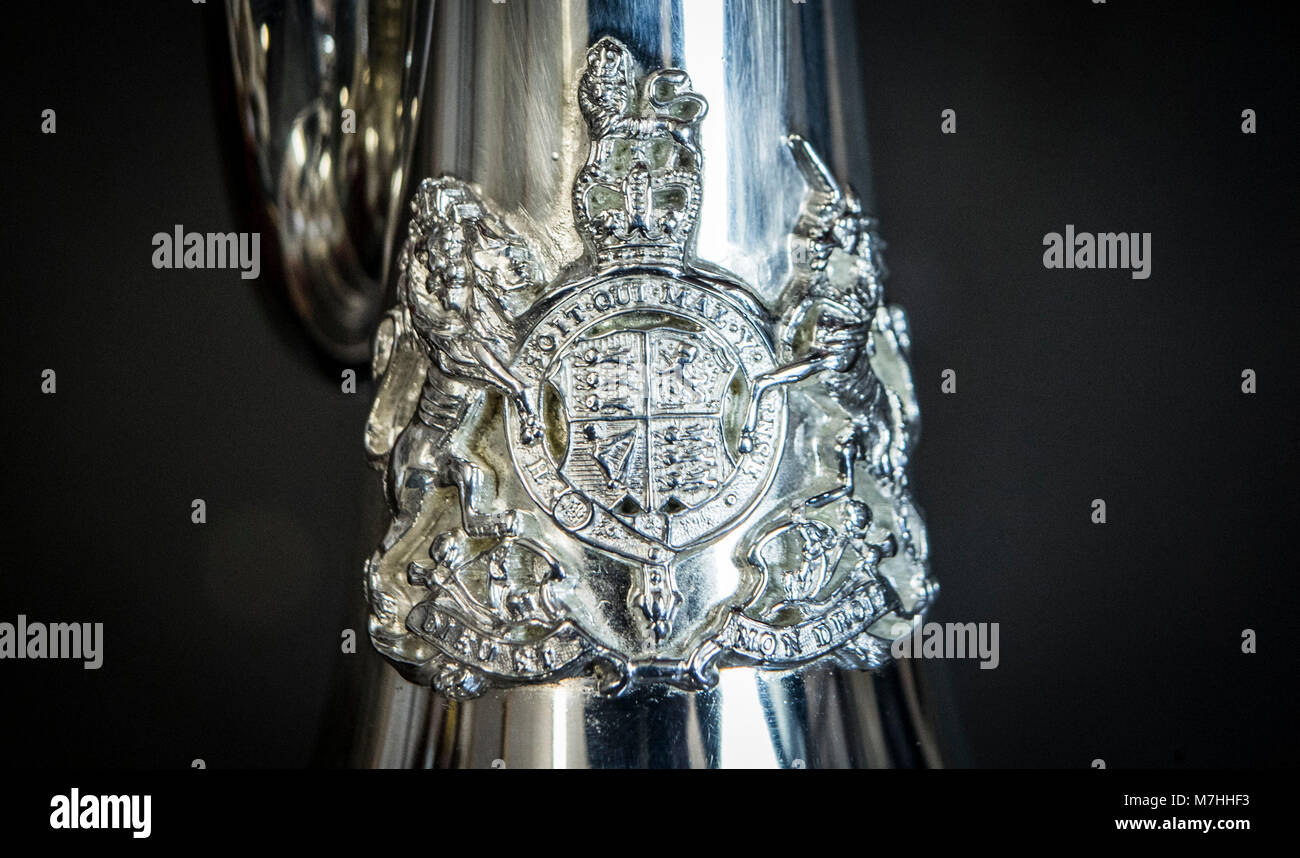 Embargoed to 0001 Sunday March 11 The royal coat of arms on a prototype Smith-Watkins fanfare trumpet produced by Richard Smith (M I) Ltd, ahead of Prince Harry and Meghan Markle's wedding, after the company was commissioned by the Ministry of Defence to produce twenty trumpets to be used for a number of royal and state occasions. Stock Photo