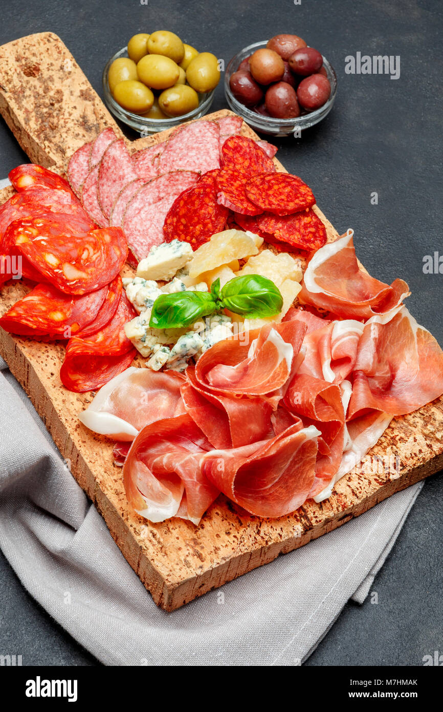 Italian prosciutto crudo or spanish jamon, cheeseand olives Stock Photo