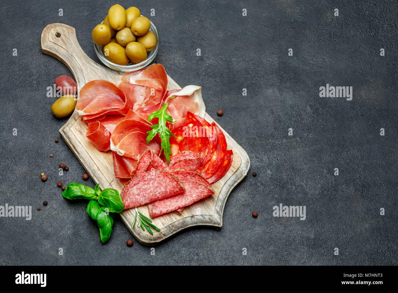 Italian prosciutto crudo or spanish jamon, sausage and olives Stock Photo Alamy