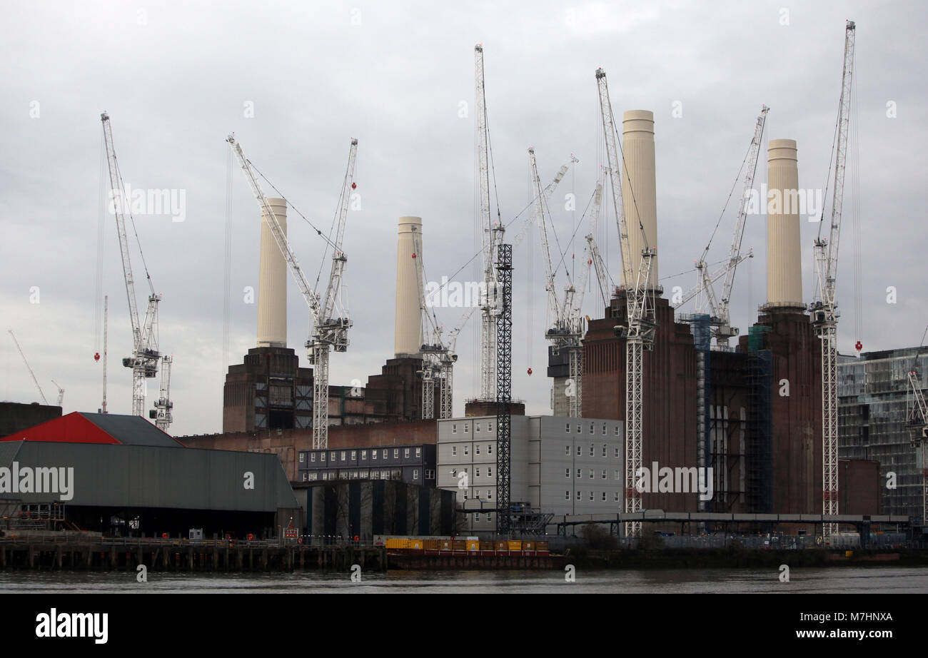 The reconstructed Chimneys of Battersea Power Station are surrounded by cranes, next to the River Thames in London, March 11, 2018. Stock Photo