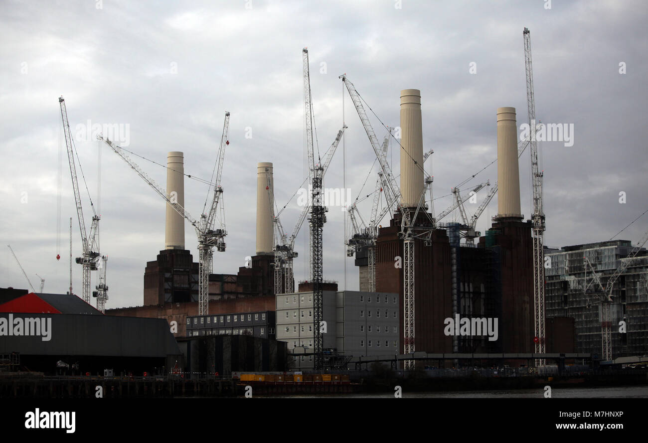 The reconstructed Chimneys of Battersea Power Station are surrounded by cranes, next to the River Thames in London, March 11, 2018. Stock Photo