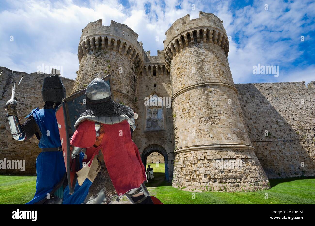 Imaginary view of fortifications of the Old Town of Rhodes in the past - Marine Gate (Sea Gate), medieval fighting knights in the foreground, Rhodes,  Stock Photo