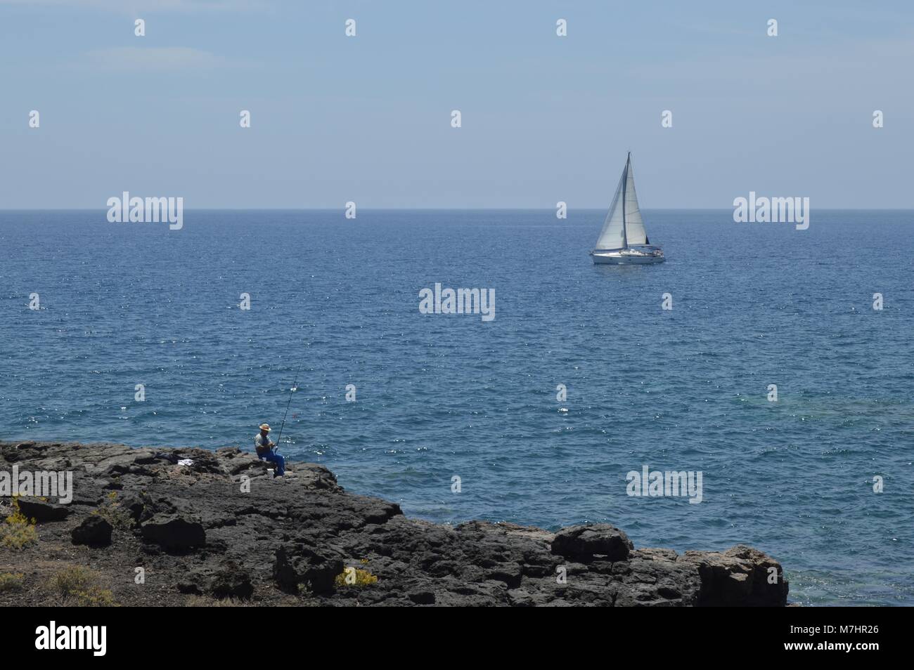 White sail boat in blue sea Stock Photo - Alamy