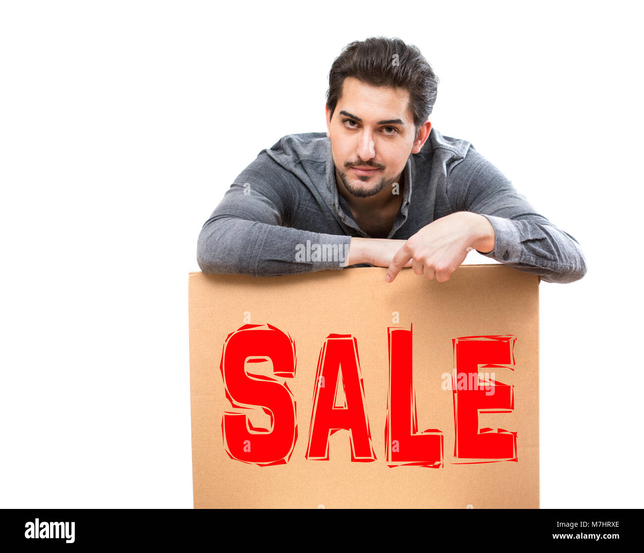 A man with a serious gaze pointing his finger on a clear sale marketing sign, perfect for advertising, promotion, banner Stock Photo
