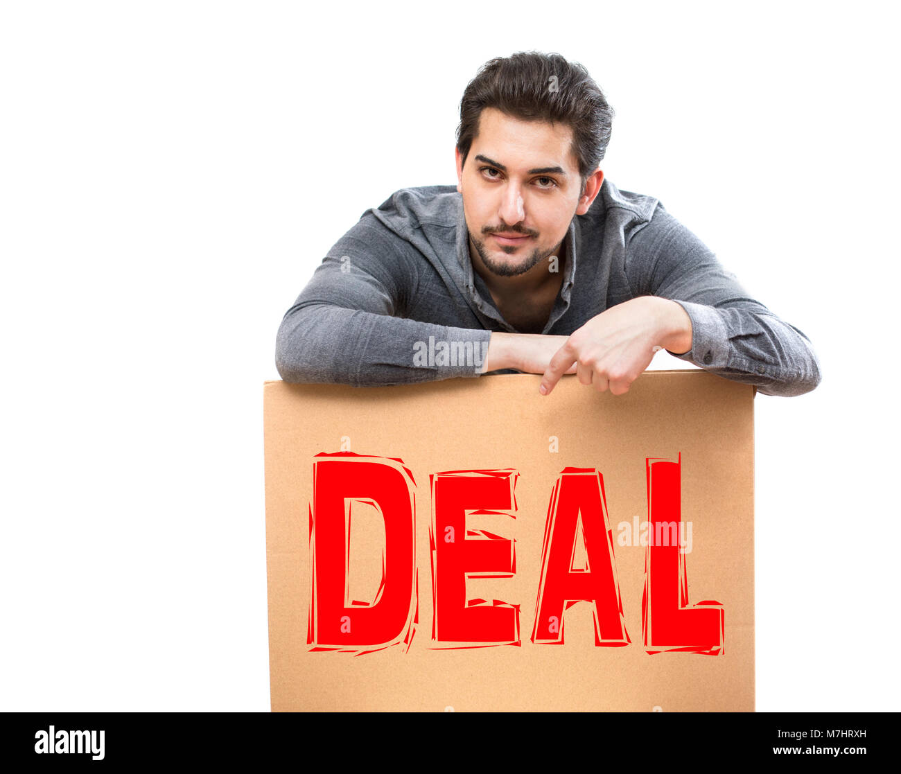 A man with a serious gaze pointing his finger on a deal marketing sign, perfect for advertising, promotion, banner Stock Photo