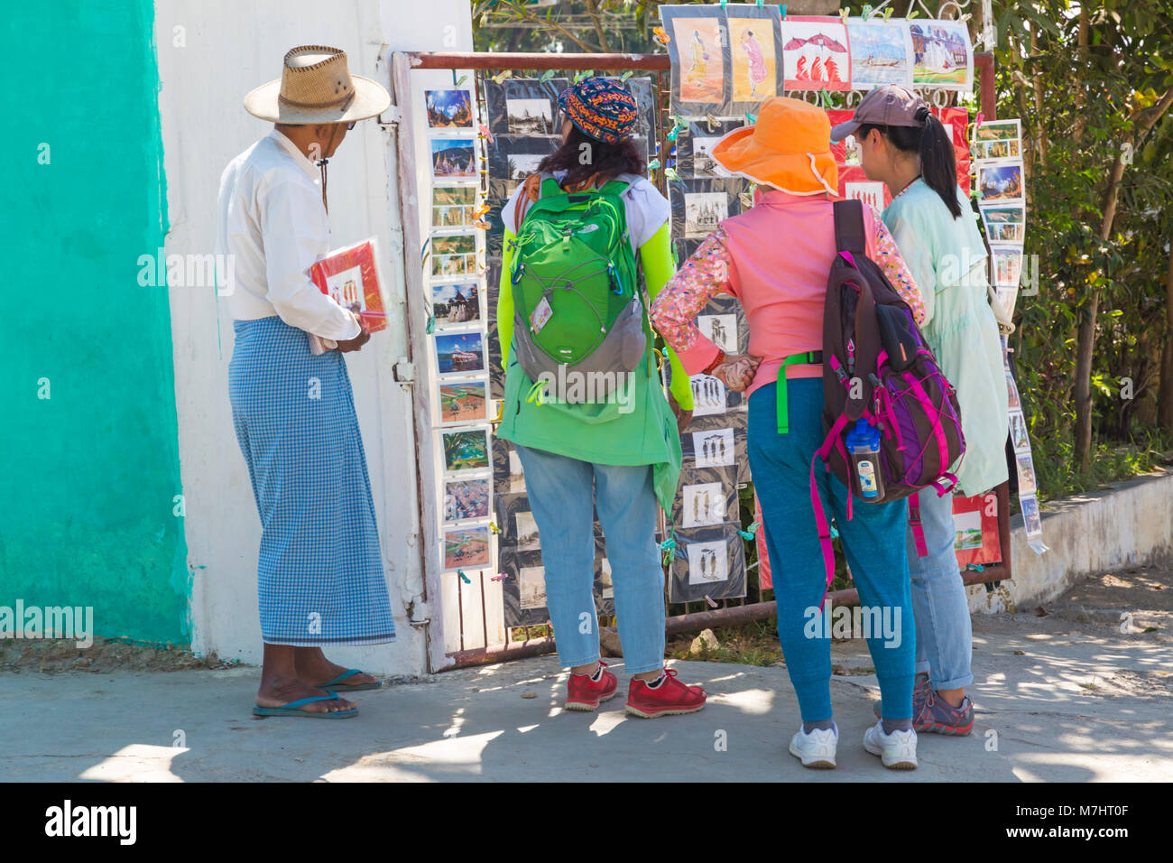 Tourists looking at souvenirs for sale at entrance to Shwe Yan Pyay monastery, Shwe Yaunghwe Monastery, Nyaungshwe, Inle Lake, Myanmar (Burma), Asia Stock Photo