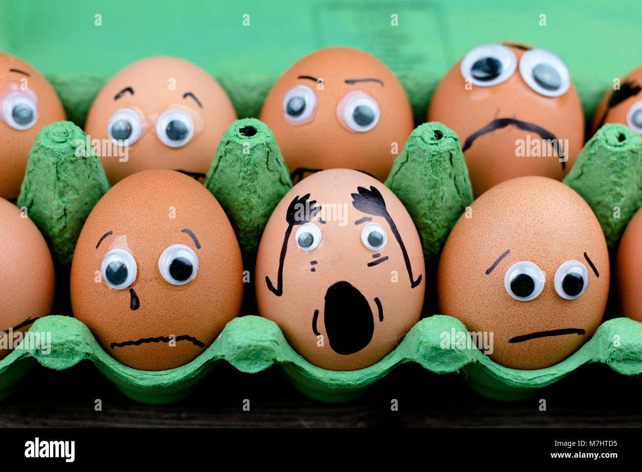 Fun concept raw eggs with googly eyes and drawn features are in shock