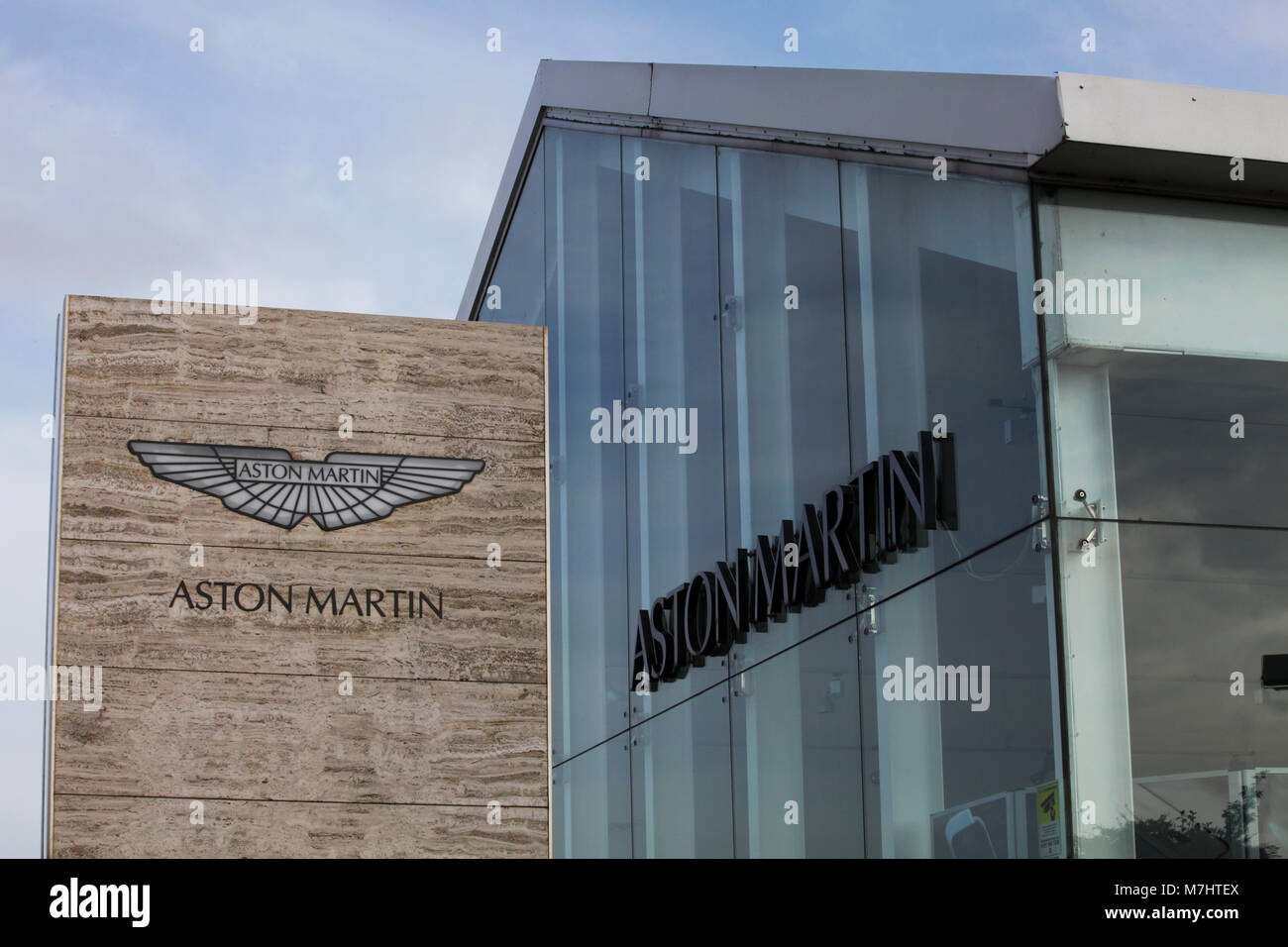 The Aston Martin logo and name on the sign outside the showroom selling the marque in Edinburgh Stock Photo
