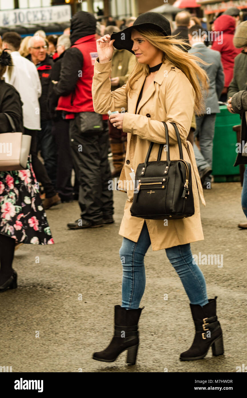 Hereford, Herefordshire, UK. 10th March, 2018. A lady holds down her hat in high winds and a rain storm during Ladies Day in Hereford on 10th March 2018. Credit: Jim Wood/Alamy Live News Stock Photo