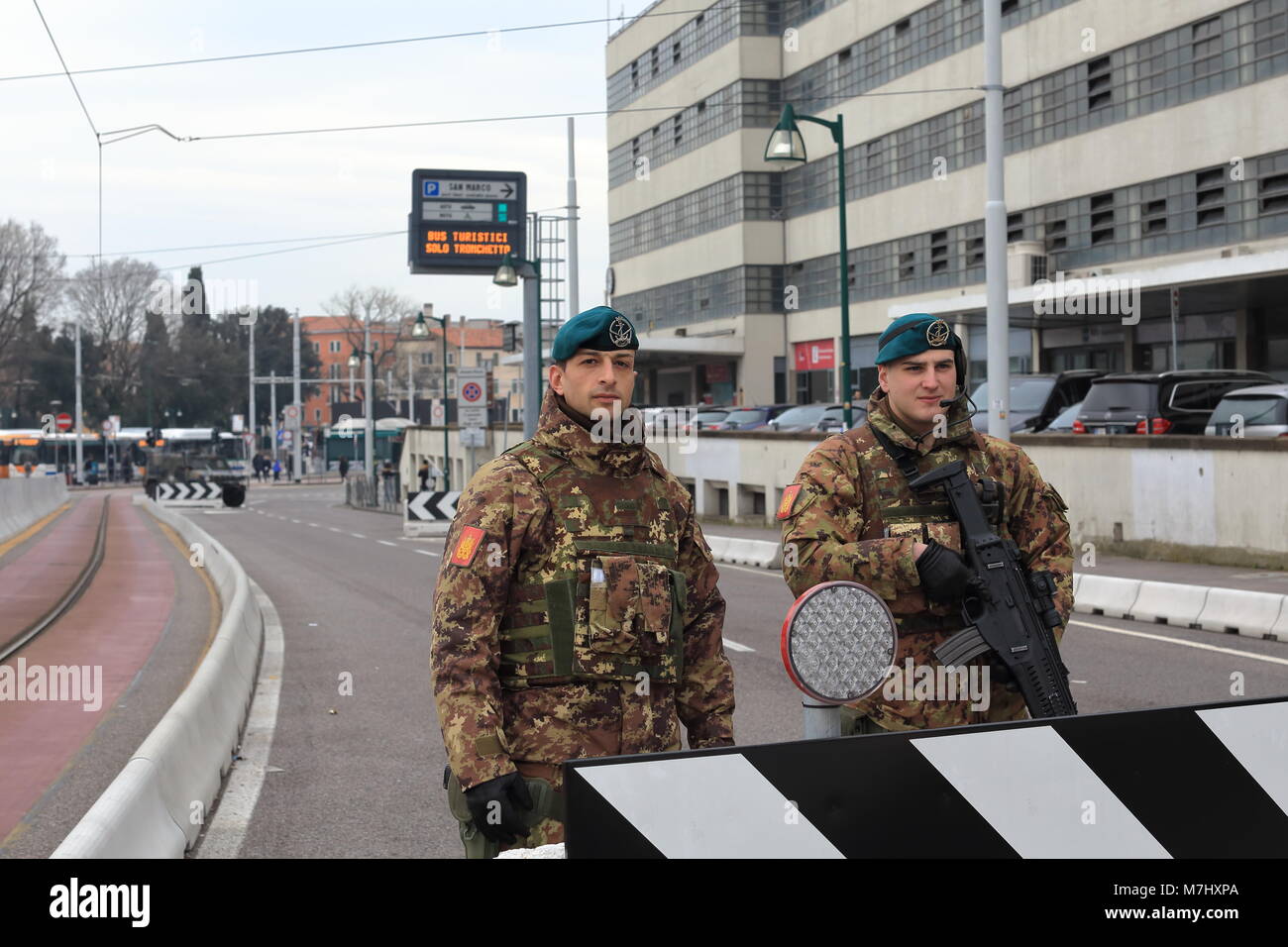 Venice, Italy. 10th, Mar 2018.  The soldiers at control barrier in Venice. In 28th August 2017, were built on the gate of Venice 'Piazzale Roma', the anti-terror barrier when started in the Venice Film Festival. After eight months the impotent jersey barriers in concrete are still there. The installation continuous to check the viability of traffic flow, and pedestrian. The barriers extending over Ponte Della Libertˆ to Piazzale Roma ahead, are designed to block any vehicular attack, an armored car was control the traffic. Credit: ALEJANDRO SALA/Alamy Live News Stock Photo