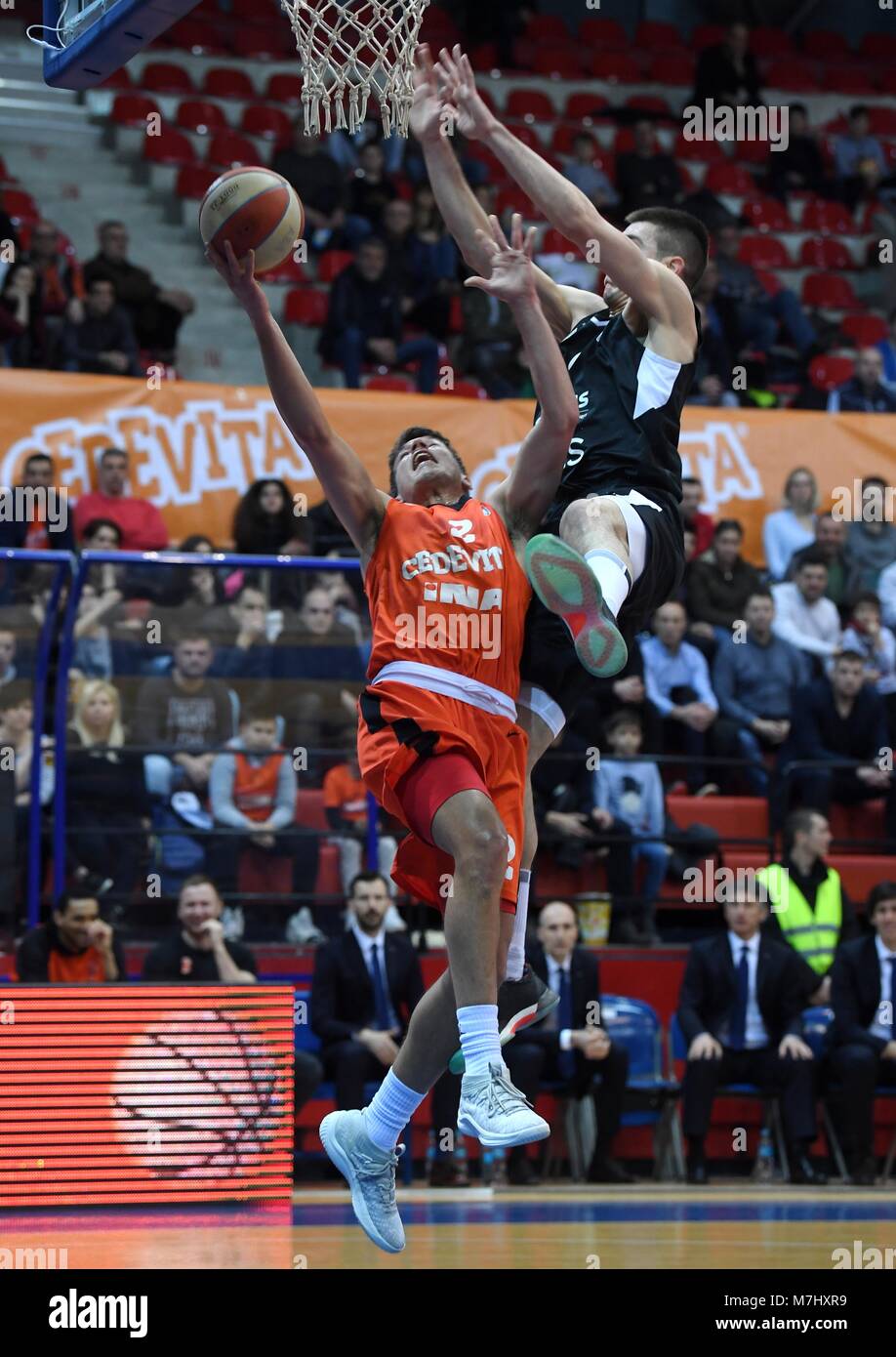 Zagreb, Croatia. 10th Mar, 2018. Filip Kruslin (L) of Cedevita goes to the basket during Round 22 ABA League basketball match between Cedevita and Partizan in Zagreb, Croatia, on March 10, 2018. Cedevita won 84-75. Credit: Marko Lukunic/Xinhua/Alamy Live News Stock Photo