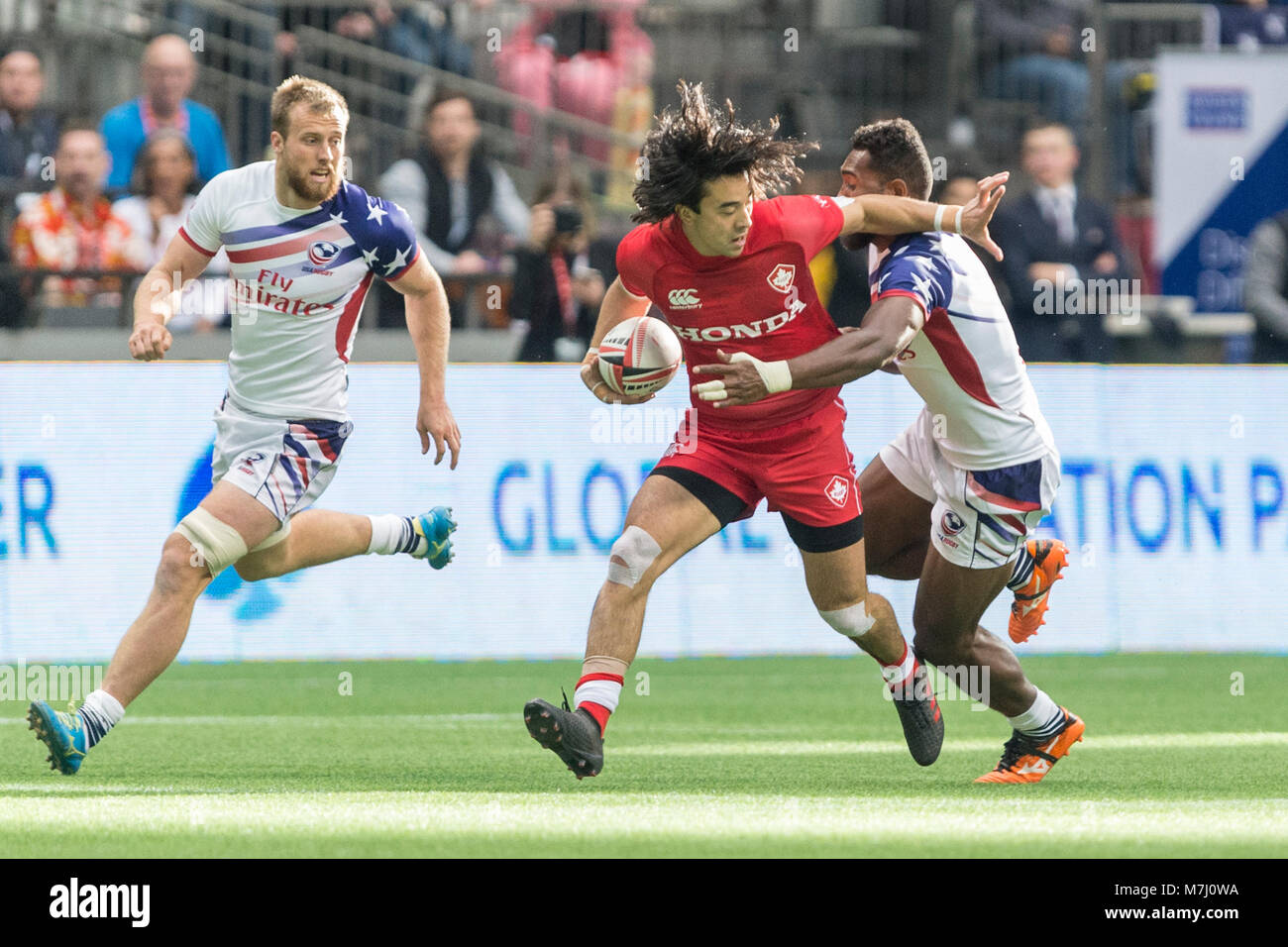 Vancouver, Canada. 10 March 2018.  Nathan Hirayama of Canada being tackled by  Mata Leuta of the USA. HSBC/ Canada Sevens-Day One BC Place.  © Gerry Rousseau/Alamy Live News Stock Photo
