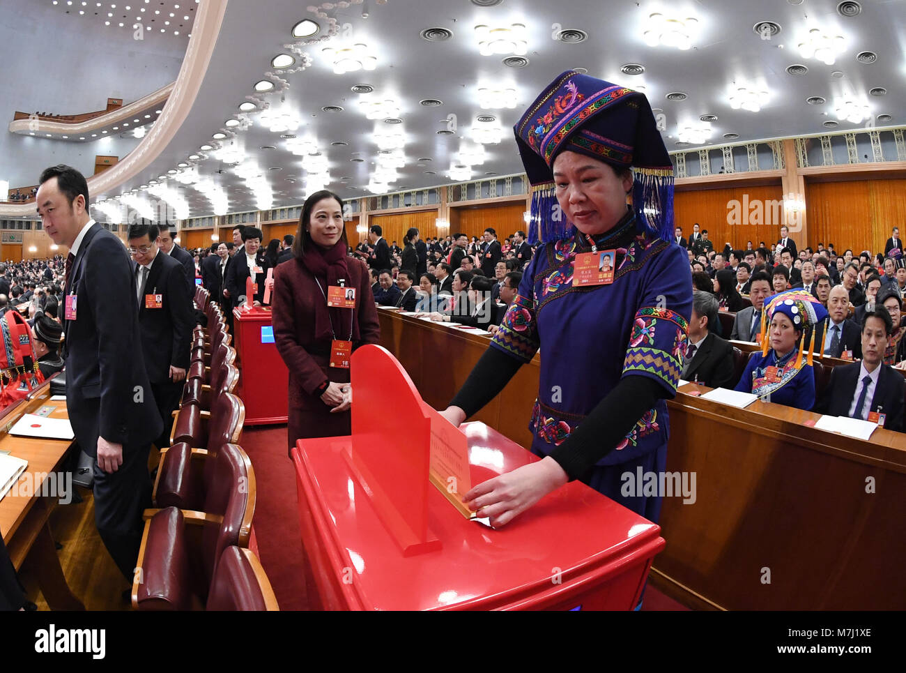 Beijing, China. 11th Mar, 2018. A deputy to the 13th National People's Congress (NPC) casts her ballot on a draft amendment to the country's Constitution at the third plenary meeting of the first session of the 13th NPC in Beijing, capital of China, March 11, 2018. Credit: Rao Aimin/Xinhua/Alamy Live News Stock Photo