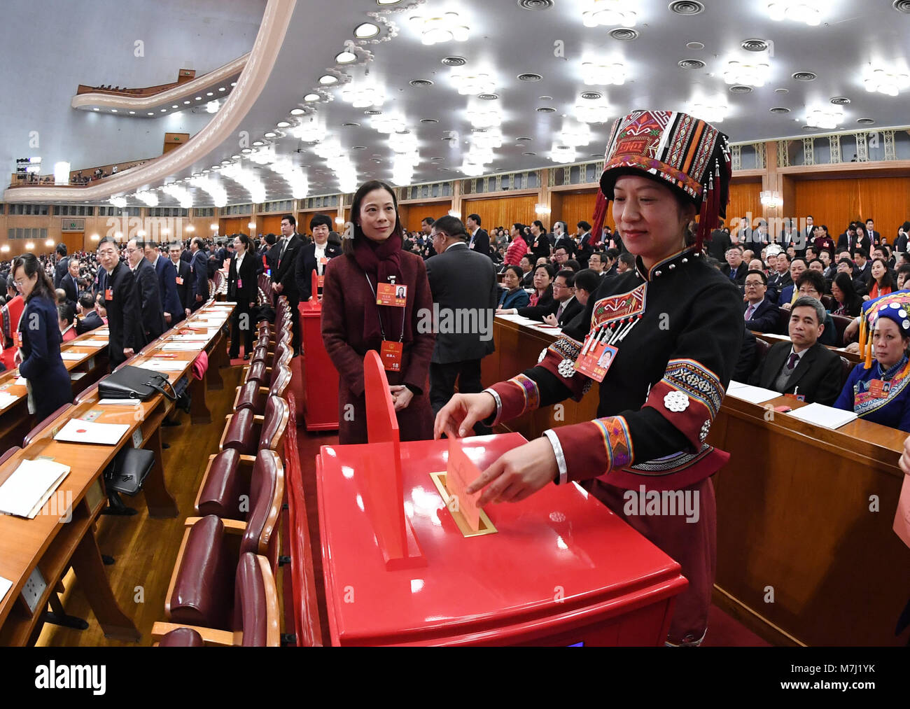 Beijing, China. 11th Mar, 2018. A deputy to the 13th National People's Congress (NPC) casts her ballot on a draft amendment to the country's Constitution at the third plenary meeting of the first session of the 13th NPC in Beijing, capital of China, March 11, 2018. Credit: Rao Aimin/Xinhua/Alamy Live News Stock Photo
