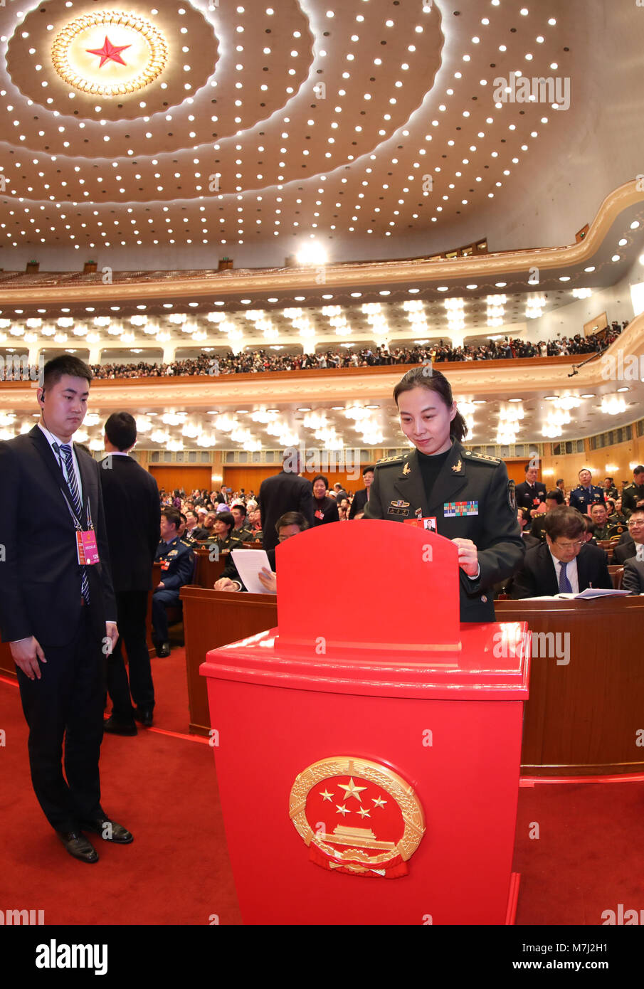 Beijing, China. 11th Mar, 2018. A deputy to the 13th National People's Congress (NPC) casts her ballot on a draft amendment to the country's Constitution at the third plenary meeting of the first session of the 13th NPC in Beijing, capital of China, March 11, 2018. Credit: Li Gang/Xinhua/Alamy Live News Stock Photo