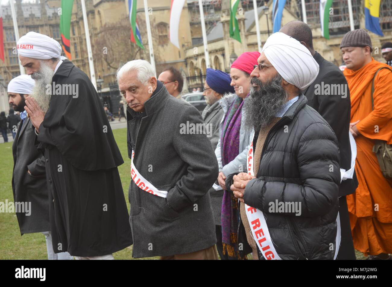 Parliament Square, London, UK. 11th March, 2018. inter religious faiths gathered to pay respects to those murdered in conversion therapy sessions , religious intolerance among the wider world mainstream religions.  conversion often entails   violent and damaging forms of persecution and cohesion programming.  a silent vigil took place on Parliament square to highlight both the practice and victims . Credit: Philip Robins/Alamy Live News Stock Photo