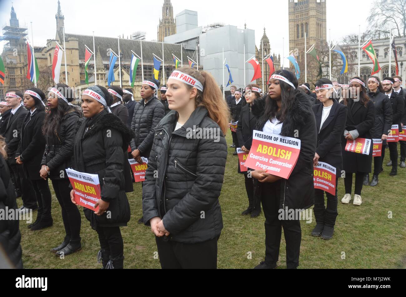 Parliament Square, London, UK. 11th March, 2018. inter religious faiths gathered to pay respects to those murdered in conversion therapy sessions , religious intolerance among the wider world mainstream religions.  conversion often entails   violent and damaging forms of persecution and cohesion programming.  a silent vigil took place on Parliament square to highlight both the practice and victims . Credit: Philip Robins/Alamy Live News Stock Photo