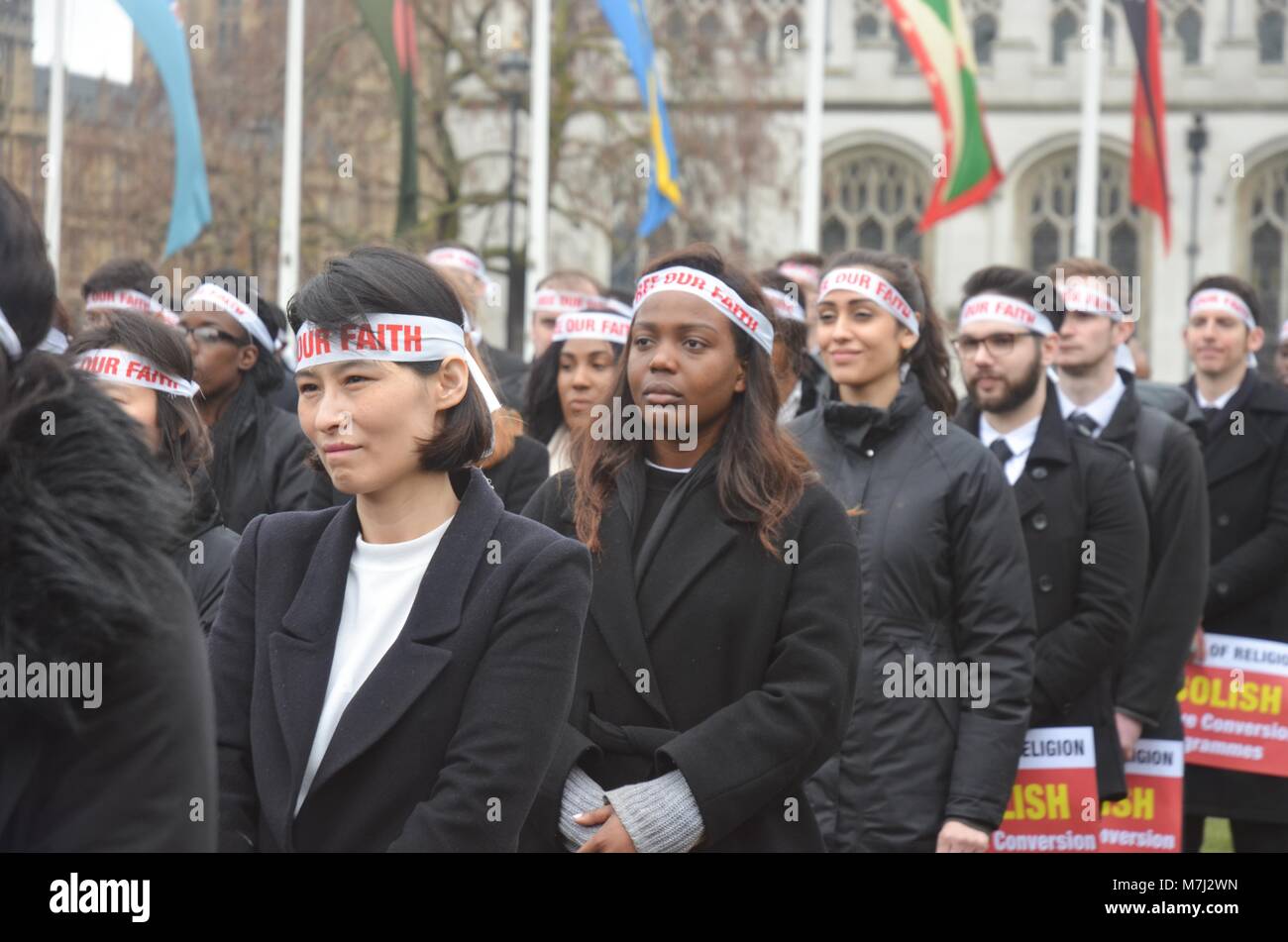 Parliament Square, London, UK. 11th March, 2018. inter religious faiths gathered to pay respects to those murdered in conversion therapy sessions , religious intolerance among the wider world mainstream religions.  conversion often entails   violent and damaging forms of persecution and cohesion programming.  a silent vigil took place on Parliament square to highlight both the practice and victims . Credit: Philip Robins/Alamy Live News Stock Photo