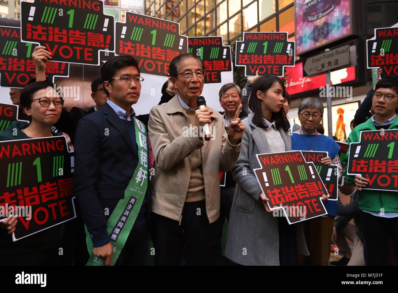 Hong Kong, CHINA. 11th Mar, 2018. Founder and former Chairman of the DEMOCRATIC PARTY, Martin Lee ( C ) calling citizens to vote out pro-China candidates in the LEGICO By-Election on the voting day, on the left stands candidate No.1 representing Democratic Party, Au Nok-hin. Mar-11, 2018.Hong Kong.ZUMA/Liau Chung Ren Credit: Liau Chung Ren/ZUMA Wire/Alamy Live News Stock Photo