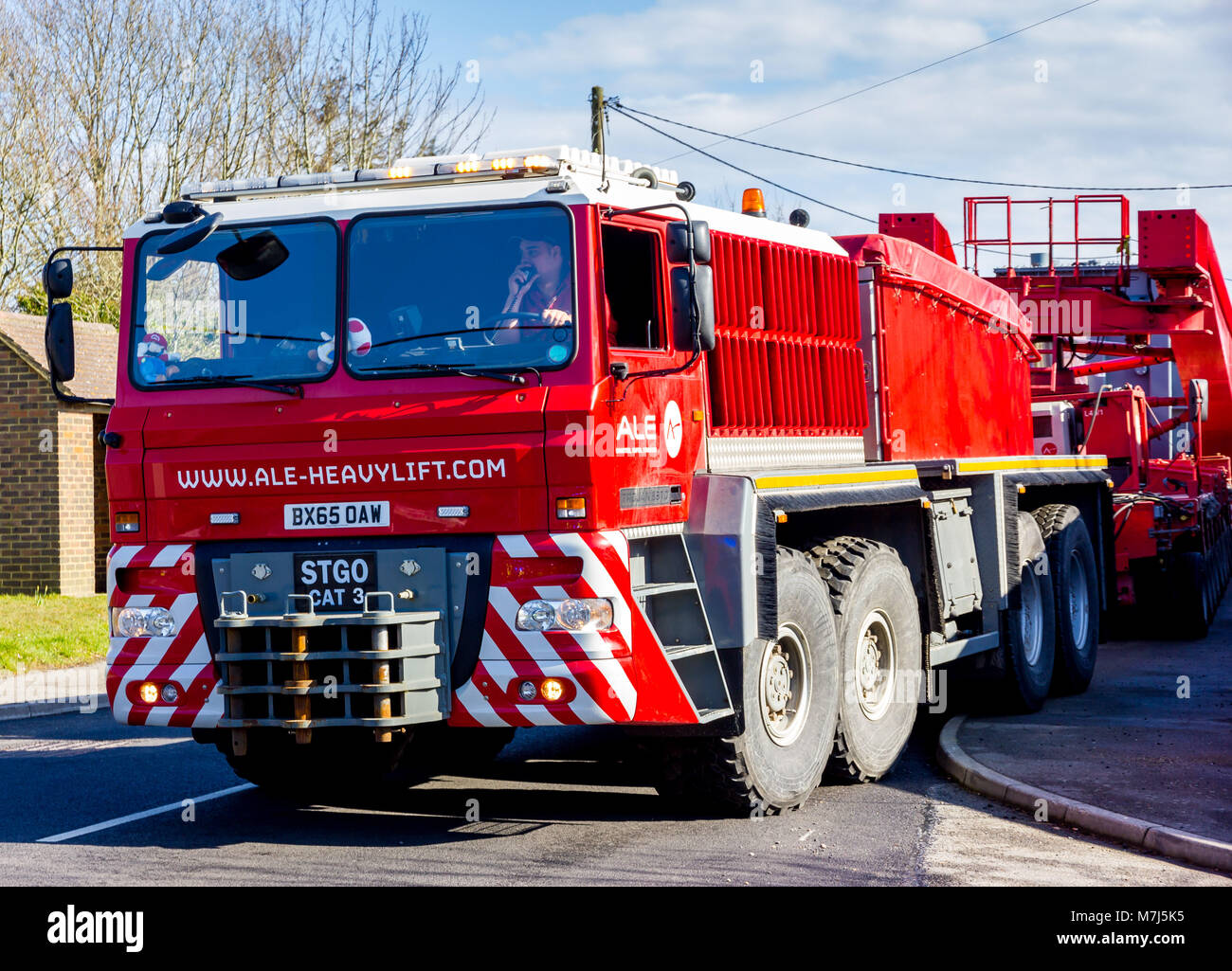 Potmans Lane, Ninfield, East Sussex, UK. 11th March 2018. Sussex police in conjunction with Highways England escort an abnormal load from Shoreham to its destination of Ninfield in East Sussex. The 78 meter long generator weighing in excess of 330 tonnes started its journey at 5.30am arriving shortly after 2pm. Credit: Alan Fraser Stock Photo