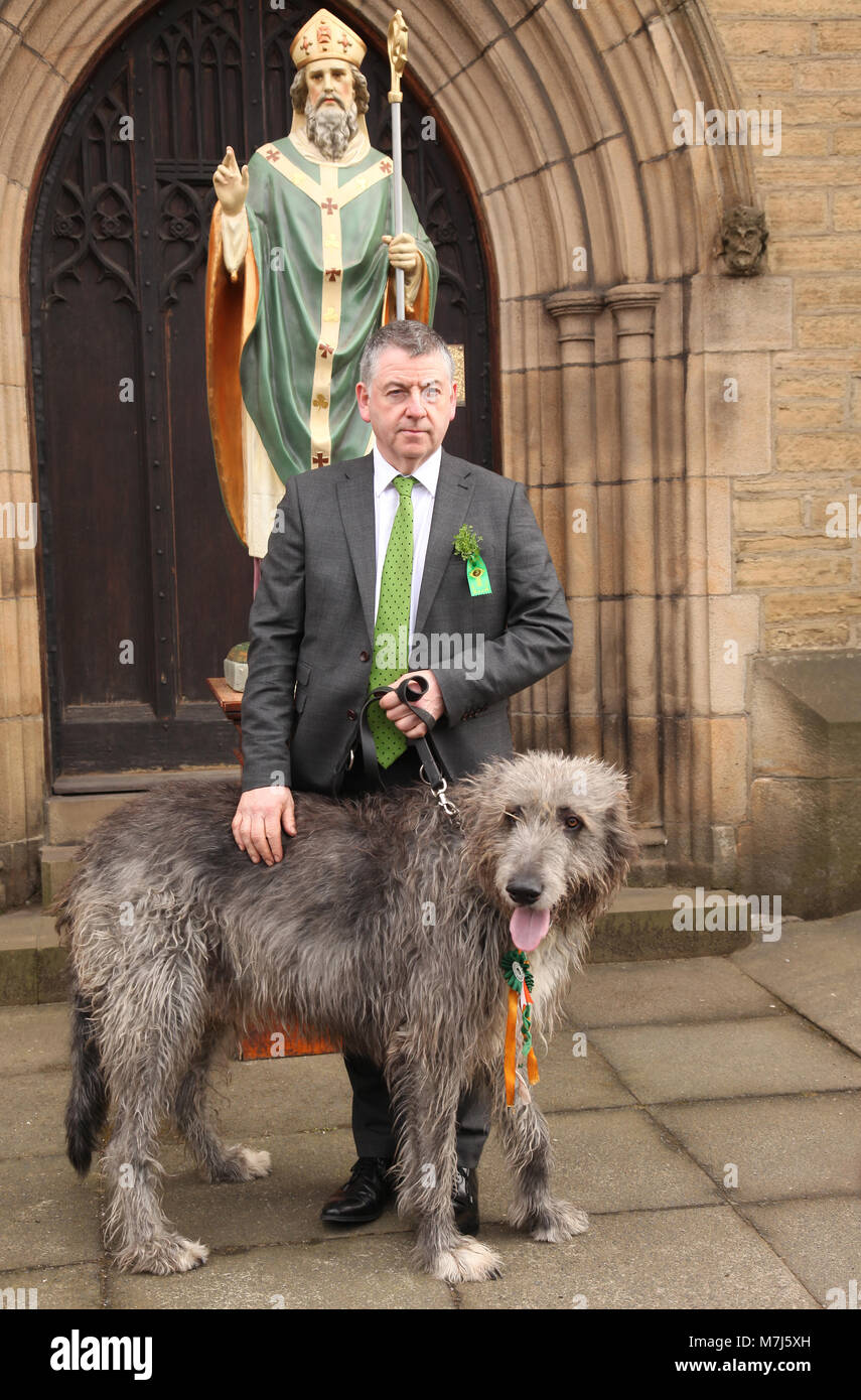 Manchester, UK 11 March 2018. Manchester Irish Festival March 2018.  The parade commenced at the Irish World Heritage Centre, In Cheetham Hill, Manchester and finished outside the town hall.  John Flanagan is pictured outside a statue of St. Patrick @ St. Chads Church Credit: Gerard Noonan/Alamy Live News Stock Photo