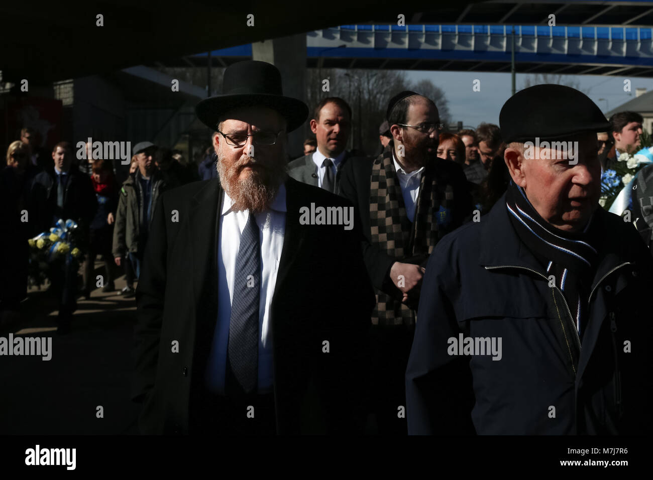 Krakow, Poland, Poland. 11th March, 2018. The Rabbi is visible in the beam of light during the March of Remembrance. Credit: Filip Radwanski/Alamy Live News Stock Photo