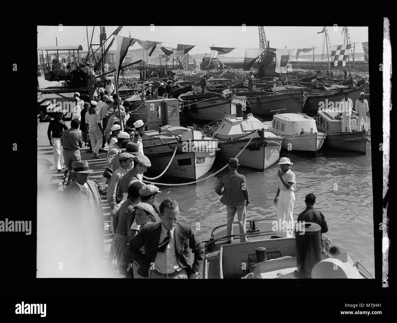 A historical image capturing a celebration at the Tel Aviv jetty ...