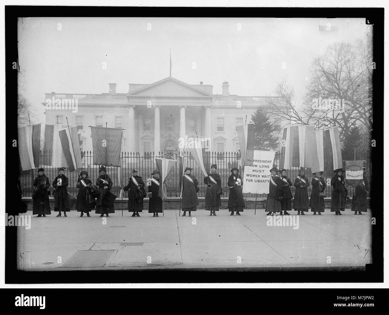 A historical photograph of women suffrage pickets outside the White ...