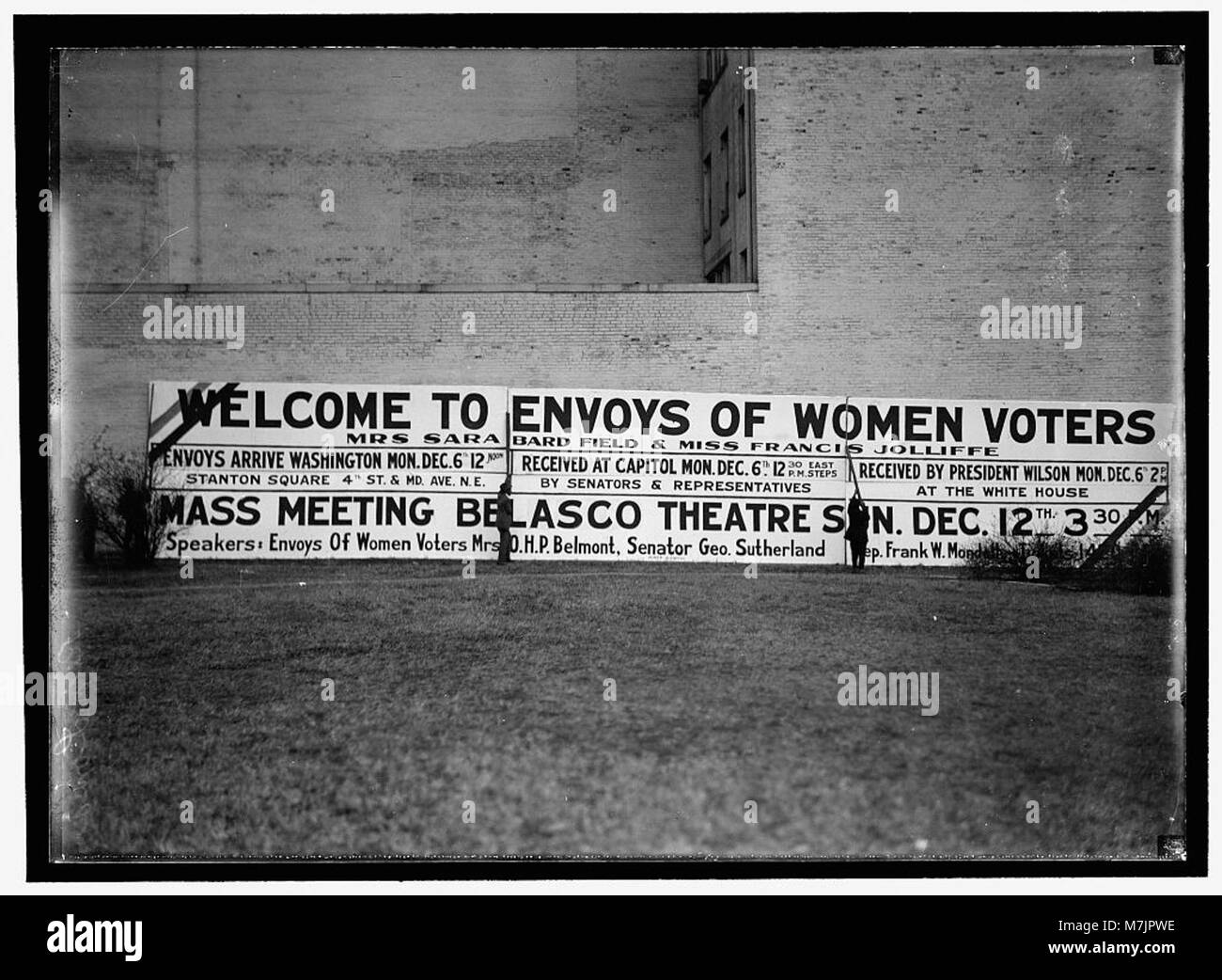 A historical photograph showing a sign welcoming the envoys of women ...