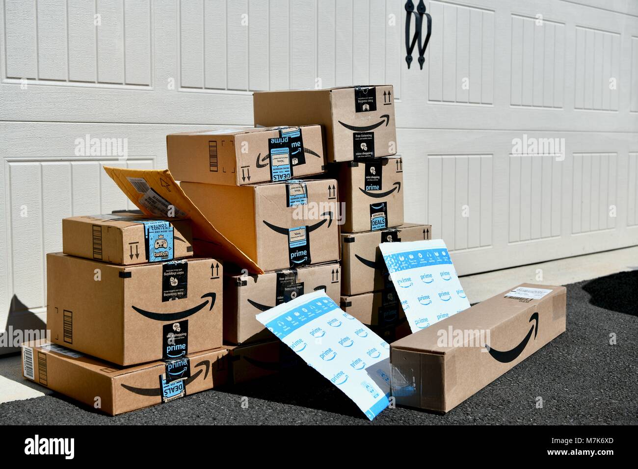 Shipment of Amazon Prime boxes and packages delivered and left in front of  garage at a residential home, USA Stock Photo - Alamy