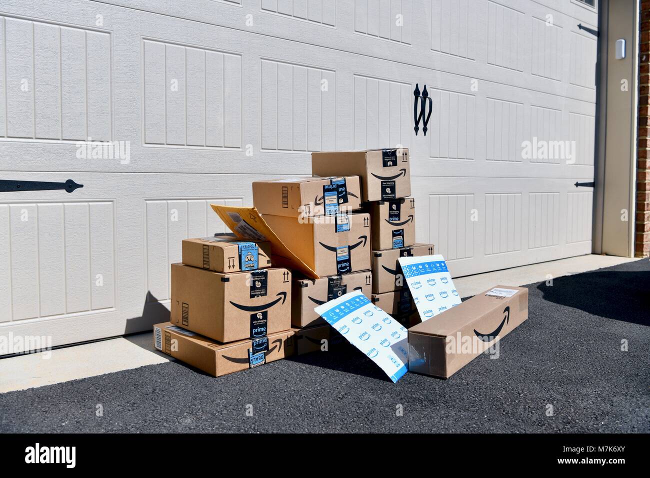 Shipment of Amazon Prime boxes and packages delivered and left in front of garage  at a residential home, USA Stock Photo - Alamy