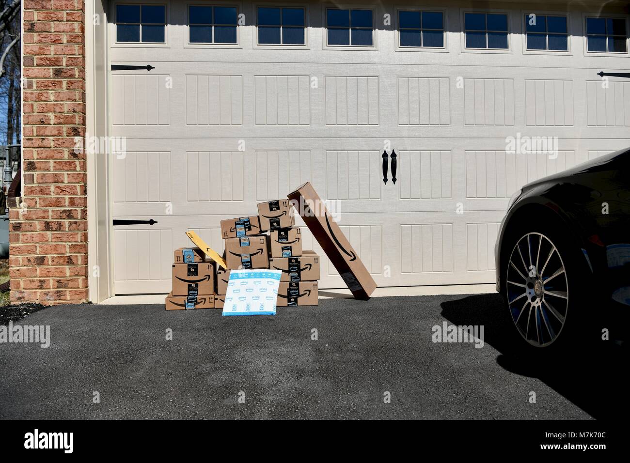 Shipment of Amazon Prime boxes and packages delivered and left in front of garage  at a residential home, USA Stock Photo - Alamy