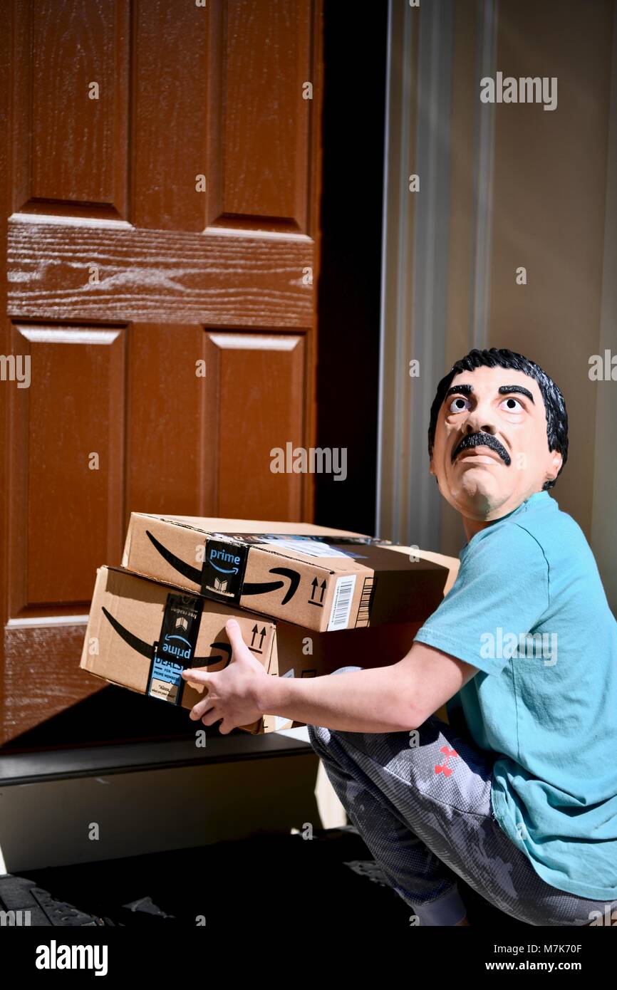 Concept of a man stealing Amazon Prime boxes from the front porch of a home, USA Stock Photo Alamy