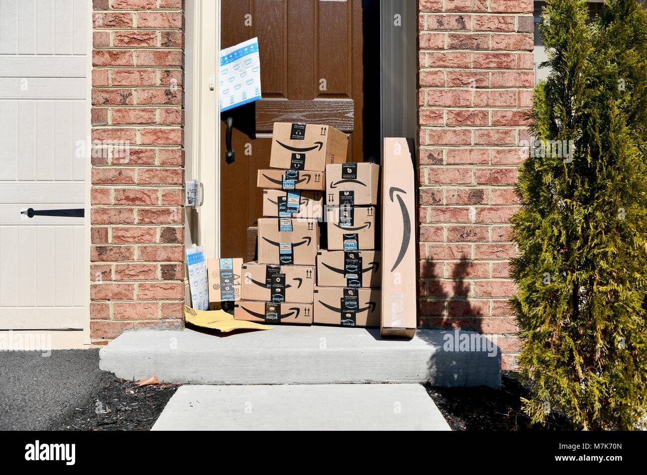 Amazon Prime boxes delivered and stacked at the front door of a
